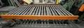 72" X 136"  PROGRESSIVE POWERED ROLLER STACKER CONVEYOR WITH 72" X 156" POWERED ROLLER RUN OUT CONVEYOR STOCK# 3896