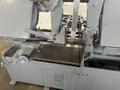 13" X 16" PEERLESS HB1316A HORIZONTAL BAND SAW W/ 10' INFEED AND 20' OUTFEED CONVEYOR. STOCK # 1164323.