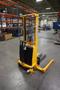 Uline H-2651 Electric Straddle Stacker Lift, 2,200# Cap, 63&quot; Max Height, 50&quot; Between Outriggers, 12 Volt Battery with Charger, 42&quot; Forks- Auction Item