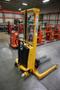 Uline H-2651 Electric Straddle Stacker Lift, 2,200# Cap, 63&quot; Max Height, 50&quot; Between Outriggers, 12 Volt Battery with Charger, 42&quot; Forks- Auction Item