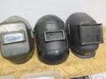 Jackson Auto Darkening Welding Helmet with (3) Older Fixed Shade Helmets and Bin of Tinted and Clear Glass Filler Plates- Auction Item