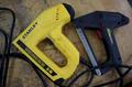 Milwuakee M12 Cordless Rivet Too., (2) Stanley Electric Staplers, Wagner Heat Gun, Extension Cord Reel, Glue Gun- Auction Item