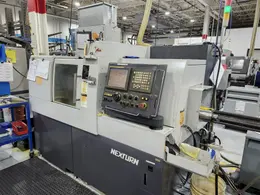 Nexturn SA-32E is a high-precision, 7-axis CNC Swiss Lathe, 32mm, 8000 RPM, Synchronous Rotary Guide Bushing, Fanuc 18i-TB, Spego 124-10 Hyd. Barfeed,  High Pressure Coolant, Chip Conveyor, 10HP, New 2007