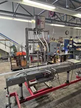 Accutek Bottling Line with Chadam Consultants 2 Head Gravity Filler, Accutek SA-1 Automatic Chuck Capper, Accutek APS106 Labelette Labeler, Everfilt Oil Filtration System, IBC Tanks