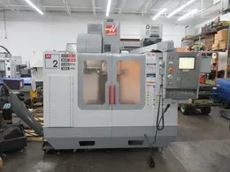 Haas VF-2 CNC Vertical Machining Center with 15,000 RPM CT-40 Spindle, High Speed Machining, Side Mount Tool Changer, 4th Axis Ready, Macros, and Chip Auger.