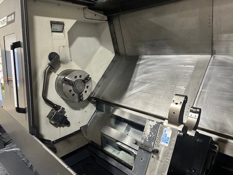 2023 DN SOLUTIONS PUMA 4100LMB CNC Universal Turning Center. Equipped for versatile 2-axis and 3-axis lathing, it features a 15" chuck, 50 HP spindle, and a machining length of 79.8" and with hydraulic open / close steady rest. Perfect for heavy-duty tasks. Fanuc Control, 50HP