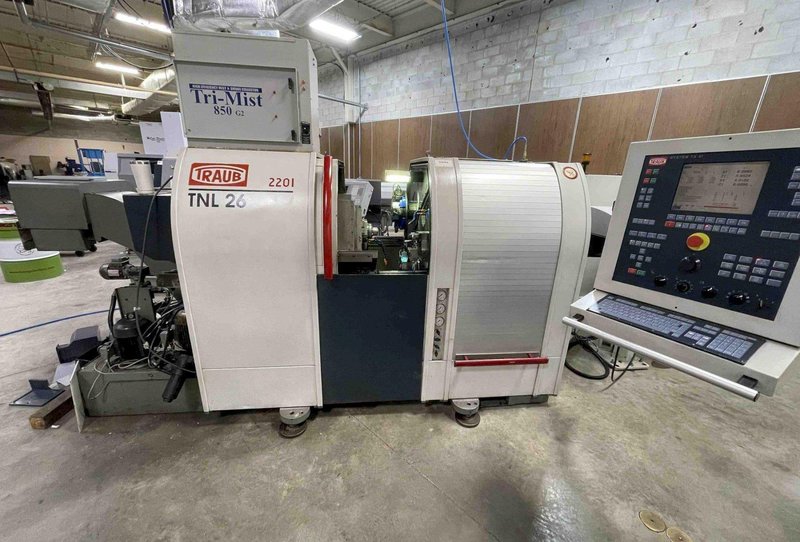 Traub TNL26 CNC Swiss Lathe, 2001- LNS Bar Feeder, Mist Collector, Conveyor, 34 Stations, Live Tools