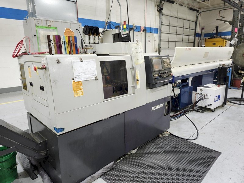 Nexturn SA-38 CNC Swiss Lathe, 38mm, 7-Axis, Turning Length: 8.3", 13 Tools, C-Axis, 8000 RPM, Fanuc 18i-TB, High Press. Coolant, Fire Suppression, Mag. Barfeeder, New 2006