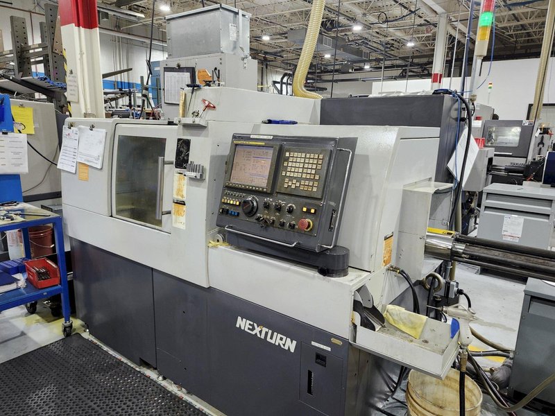 Nexturn SA-32E is a high-precision, 7-axis CNC Swiss Lathe, 32mm, 8000 RPM, Synchronous Rotary Guide Bushing, Fanuc 18i-TB, Spego 124-10 Hyd. Barfeed,  High Pressure Coolant, Chip Conveyor, 10HP, New 2007