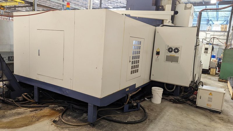 TAKUMI, V32, CNC VERTICAL MACHINING CENTRE, 10,000 RPM SPINDLE, TRAVELS (X,Y,Z): 3200 MM X 1066MM X 750 MM (126&quot; X 42&quot; X 30), DISTANCE FROM NOSE TO SPINDLE:  200MM TO 950MM, DISTANCE FROM SPINDLE NOSE TO THE Z-AXIS GUIDEWAY: 1120MM, T-SLOT TABLE SIZE: 3200MM X 1025MM (126&quot; X 40&quot;), MAX TABLE LOAD, 4500 KG (9,920 LBS), 32 TOOL ATC, TABLE SIZE: 42&quot; X 130&quot;, CAT 50, 30 KW, SPINDLE FLOOD AND THROUGH COOLANT, AIR BLAST, COOLANT FILTER SYSTEM, CHIP WASH DOWN SYSTEM, CHILLED BALL SCREW AND SPINDLE, 4-AXIS CAPABLE,  LEFT AND RIGHT CHIP CONVEYOR,  MITSUBISHI, MEDLAS 60S, CNC CONTROL, 2006, 220/3/60 50 AMP, MACHINE WEIGHT:  52.500 LBS. FLOOR SPACE (W, L, H) 295&quot; X 173&quot; X 139.7&quot; (APPROX.), S/N K0133