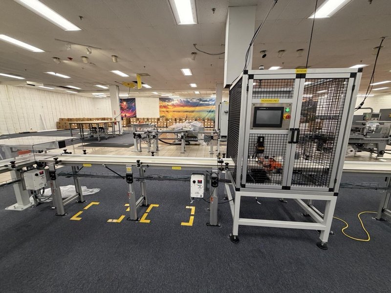 Complete Packaging Line for trays / flat Product including Custom Conveyor System, (2) Texwrap L-Bar Sealers and Heat Tunnels, Econocorp Automatic Cartoner and Case Packer and CTM Case labeler, 2023