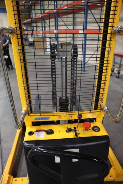 Uline H-5439 Electric Straddle Stacker Lift, 2,200# Cap, 63" Max Height, 50" Between Outriggers, 12 Volt Battery with Charger, 42" Forks- Auction Item