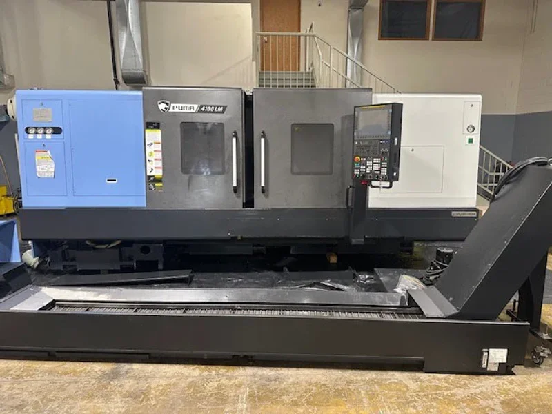 2023 DN SOLUTIONS PUMA 4100LMB CNC Universal Turning Center. Equipped for versatile 2-axis and 3-axis lathing, it features a 15" chuck, 50 HP spindle, and a machining length of 79.8" and with hydraulic open / close steady rest. Perfect for heavy-duty tasks. Fanuc Control, 50HP
