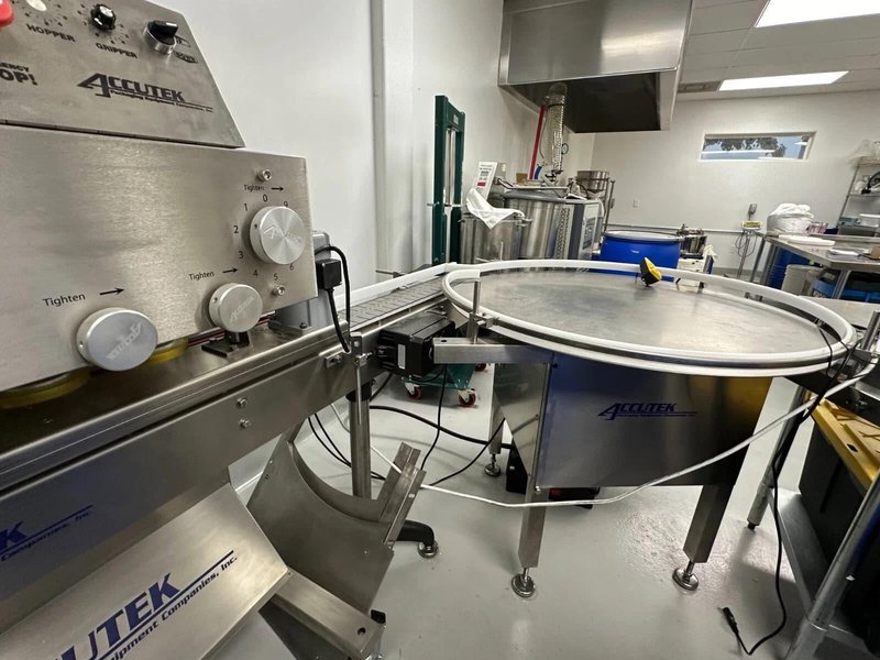 Accutek Hot Fill Bottle Filling Line with AVF2-16 2-Head Volumetric Bottle Filler with Heated Hopper, 2018 – Previously ran 1 Oz, 2 Oz, 4 Oz, 8 Oz, and 16 Oz Boston round Bottles and 1 Oz and 4 Oz Topical Jars