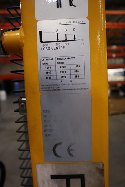 Uline H-2651 Electric Straddle Stacker Lift, 2,200# Cap, 63&quot; Max Height, 50&quot; Between Outriggers, 12 Volt Battery with Charger, 42&quot; Forks- Auction Item