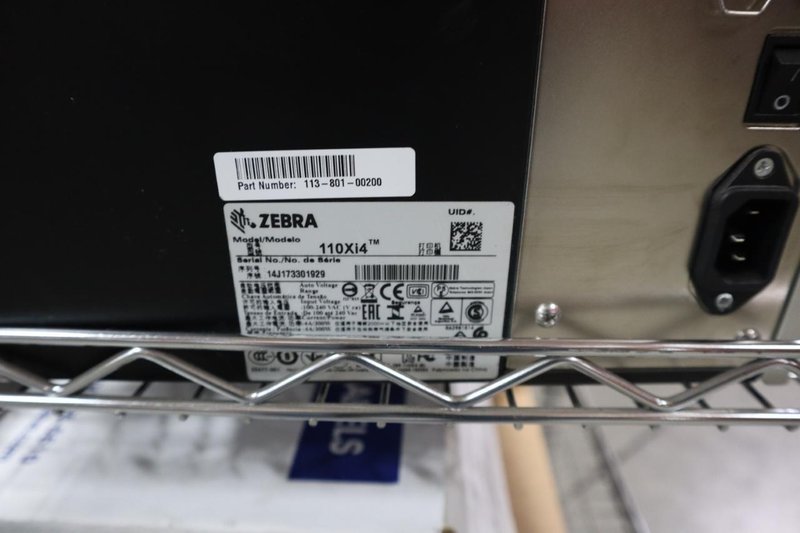 (2) Zebra 110Xi4 Label Printers, 203 dpi, 4&quot; Wide Label Cap - On Wire Cart with Labels- Auction Item