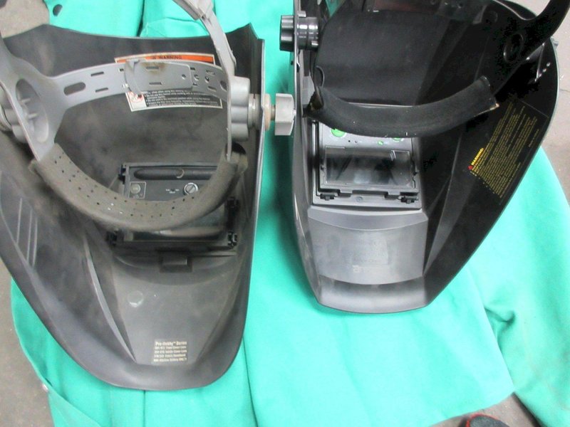 Welding Equipment: (2) Darkening Welding Helmet, (2)Curtains , 2XL Welding Jacket, Welding Wire, Brush- Auction Item