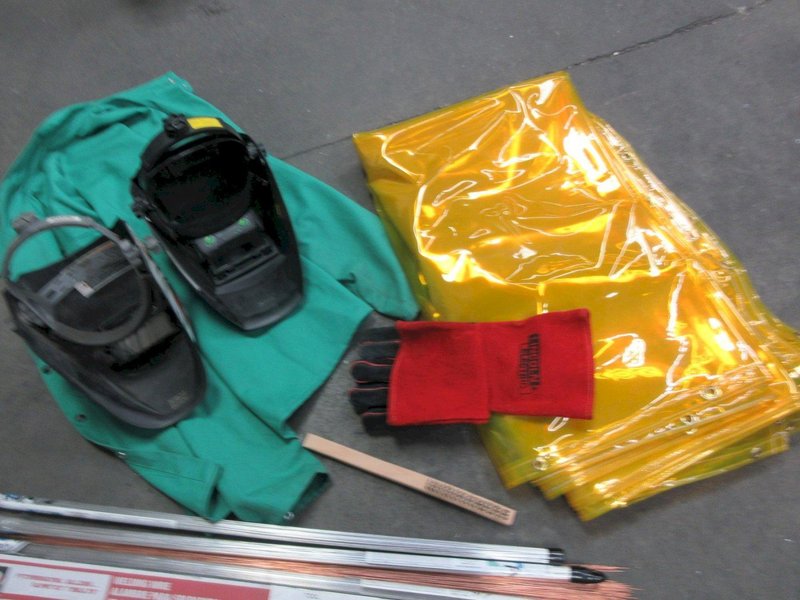 Welding Equipment: (2) Darkening Welding Helmet, (2)Curtains , 2XL Welding Jacket, Welding Wire, Brush- Auction Item