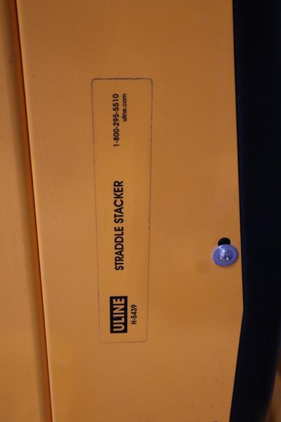 Uline H-5439 Electric Straddle Stacker Lift, 2,200# Cap, 63" Max Height, 50" Between Outriggers, 12 Volt Battery with Charger, 42" Forks- Auction Item