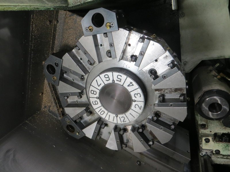 Okuma Genos L250E CNC Turning Center, OSP-P300L/R CNC Control, 8&quot; Chuck, Tool Setter, Parts Catcher, 12-Station Turret, Tailstock, Chip Conveyor