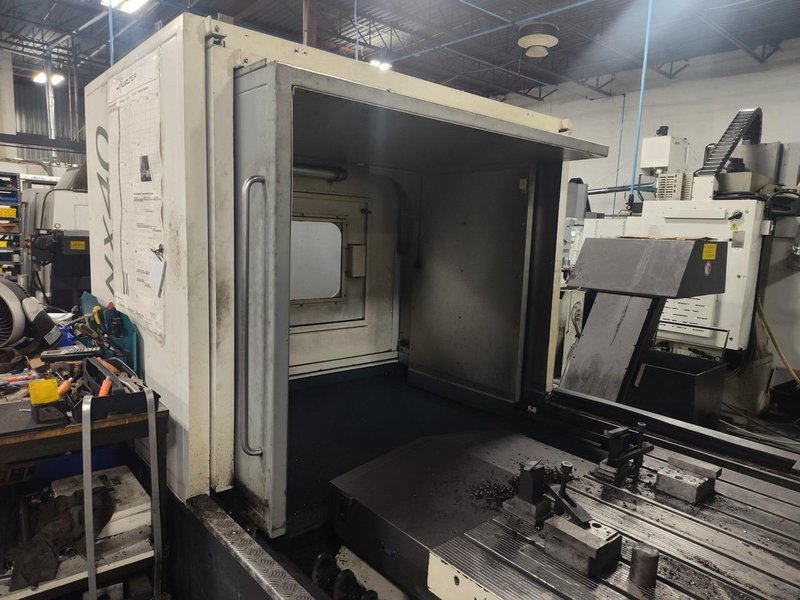 Huron NX40 Double Column Bridge Gantry Machining Center, 2013 – J30 High Pressure Through Spindle Coolant System, Chip Conveyor, Tooling, Siemens Sinumerik Control