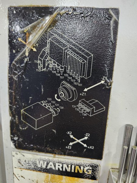 Nexturn SA-32E is a high-precision, 7-axis CNC Swiss Lathe, 32mm, 8000 RPM, Synchronous Rotary Guide Bushing, Fanuc 18i-TB, Spego 124-10 Hyd. Barfeed,  High Pressure Coolant, Chip Conveyor, 10HP, New 2007