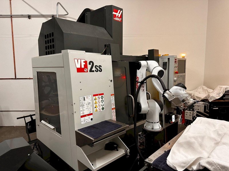 2024 HAAS VF-2SS with HC10 6-Axis Cobot with low hours. Vertical Machining Center