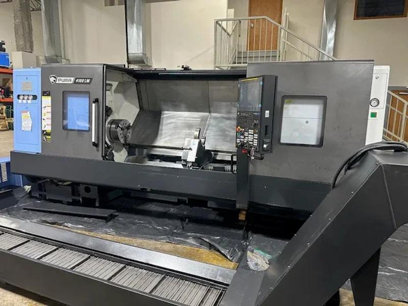 2023 DN SOLUTIONS PUMA 4100LMB CNC Universal Turning Center. Equipped for versatile 2-axis and 3-axis lathing, it features a 15" chuck, 50 HP spindle, and a machining length of 79.8" and with hydraulic open / close steady rest. Perfect for heavy-duty tasks. Fanuc Control, 50HP