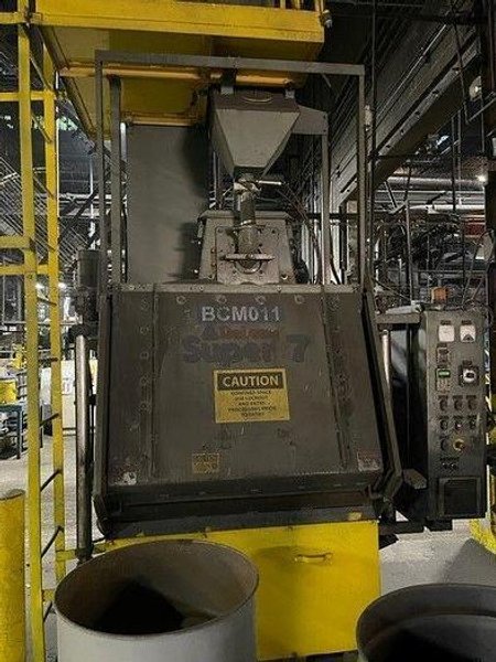 2012 
DeLong 7 super rubber belt tumblast machine rated at 7 cu ft capacity, 20hp direct drive shot wheel, very good condition