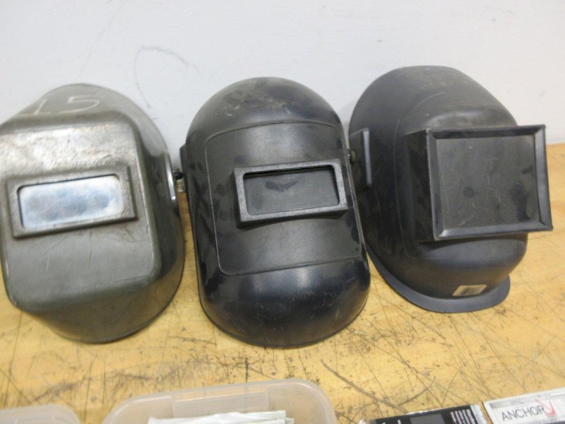 Jackson Auto Darkening Welding Helmet with (3) Older Fixed Shade Helmets and Bin of Tinted and Clear Glass Filler Plates- Auction Item