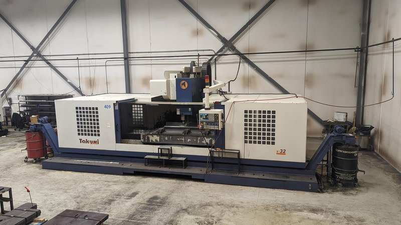 TAKUMI, V32, CNC VERTICAL MACHINING CENTRE, 10,000 RPM SPINDLE, TRAVELS (X,Y,Z): 3200 MM X 1066MM X 750 MM (126&quot; X 42&quot; X 30), DISTANCE FROM NOSE TO SPINDLE:  200MM TO 950MM, DISTANCE FROM SPINDLE NOSE TO THE Z-AXIS GUIDEWAY: 1120MM, T-SLOT TABLE SIZE: 3200MM X 1025MM (126&quot; X 40&quot;), MAX TABLE LOAD, 4500 KG (9,920 LBS), 32 TOOL ATC, TABLE SIZE: 42&quot; X 130&quot;, CAT 50, 30 KW, SPINDLE FLOOD AND THROUGH COOLANT, AIR BLAST, COOLANT FILTER SYSTEM, CHIP WASH DOWN SYSTEM, CHILLED BALL SCREW AND SPINDLE, 4-AXIS CAPABLE,  LEFT AND RIGHT CHIP CONVEYOR,  MITSUBISHI, MEDLAS 60S, CNC CONTROL, 2006, 220/3/60 50 AMP, MACHINE WEIGHT:  52.500 LBS. FLOOR SPACE (W, L, H) 295&quot; X 173&quot; X 139.7&quot; (APPROX.), S/N K0133