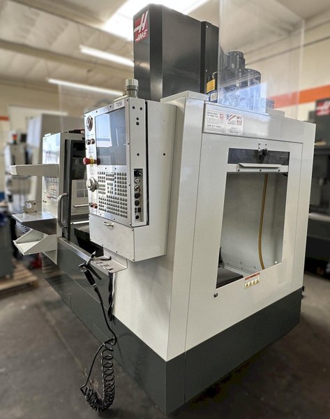 HAAS VM-2 CNC Vertical Machining Center 2011 equipped with quipped with 30"x20"x20" Travels, Haas Control, 4th Axis Drive, 24 ATC Side Mount Tool Changer, Tool Pre-Setter, Cool, Chip Auger