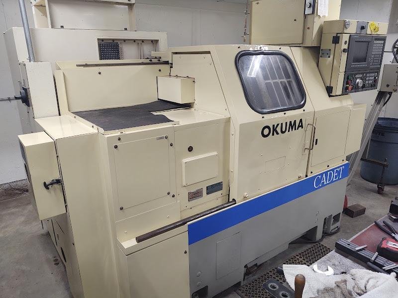 OKUMA Cadet LNC-8C CNC Turning Center, S/N D764, with 10" chuck.