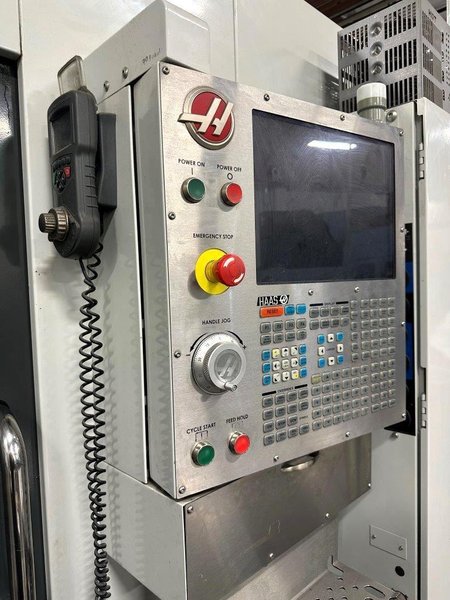 Haas EC-500 Horizontal Machining Center 2014 equipped with Haas CNC Control, CT40 Spindle, 70 Station Automatic Tool Changer, 4th Axis, Probing, Tomb Stones, TSC, Remote Hand Jog, Chip Conveyor, Coolant Pump