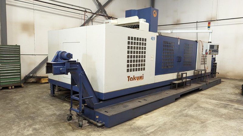 TAKUMI, V32, CNC VERTICAL MACHINING CENTRE, 10,000 RPM SPINDLE, TRAVELS (X,Y,Z): 3200 MM X 1066MM X 750 MM (126&quot; X 42&quot; X 30), DISTANCE FROM NOSE TO SPINDLE:  200MM TO 950MM, DISTANCE FROM SPINDLE NOSE TO THE Z-AXIS GUIDEWAY: 1120MM, T-SLOT TABLE SIZE: 3200MM X 1025MM (126&quot; X 40&quot;), MAX TABLE LOAD, 4500 KG (9,920 LBS), 32 TOOL ATC, TABLE SIZE: 42&quot; X 130&quot;, CAT 50, 30 KW, SPINDLE FLOOD AND THROUGH COOLANT, AIR BLAST, COOLANT FILTER SYSTEM, CHIP WASH DOWN SYSTEM, CHILLED BALL SCREW AND SPINDLE, 4-AXIS CAPABLE,  LEFT AND RIGHT CHIP CONVEYOR,  MITSUBISHI, MEDLAS 60S, CNC CONTROL, 2006, 220/3/60 50 AMP, MACHINE WEIGHT:  52.500 LBS. FLOOR SPACE (W, L, H) 295&quot; X 173&quot; X 139.7&quot; (APPROX.), S/N K0133