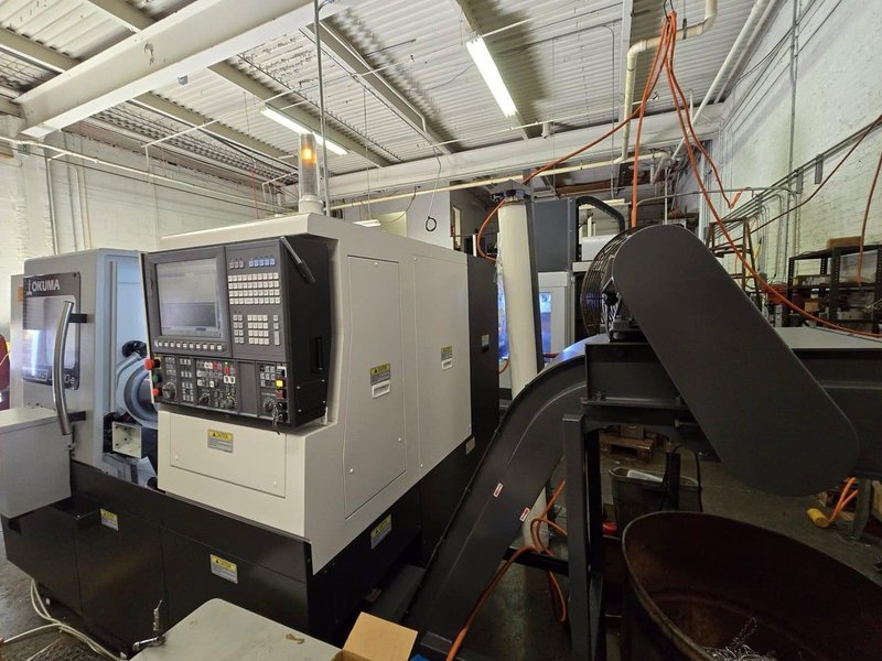 Okuma Genos L3000-e CNC Lathe, 2023 – Parts Catcher, Tailstock, Barfeed Interface