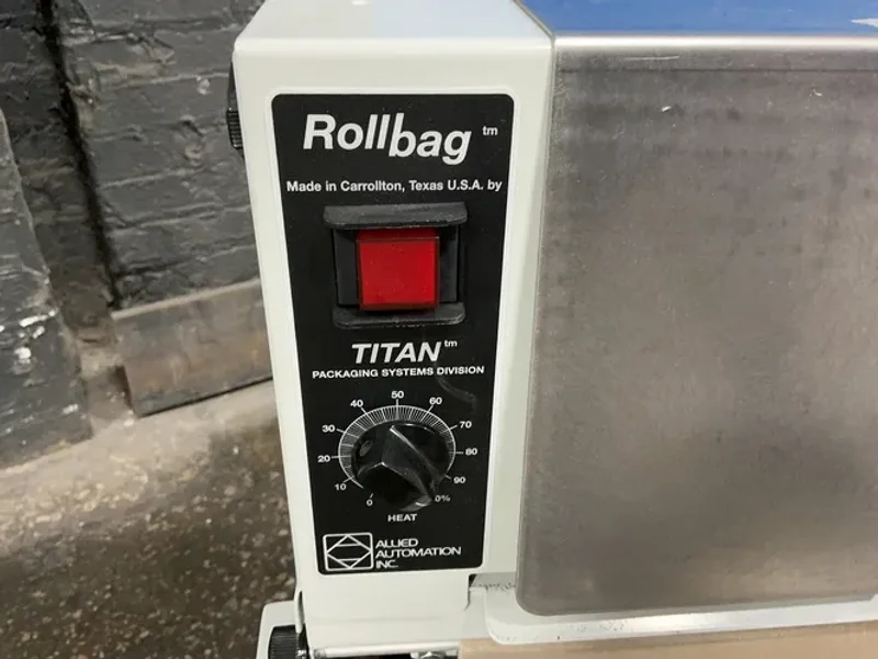 ALLIED AUTOMATION INC ROLL MACHINE   -  1055 ROLLBAG SEMIAUTO