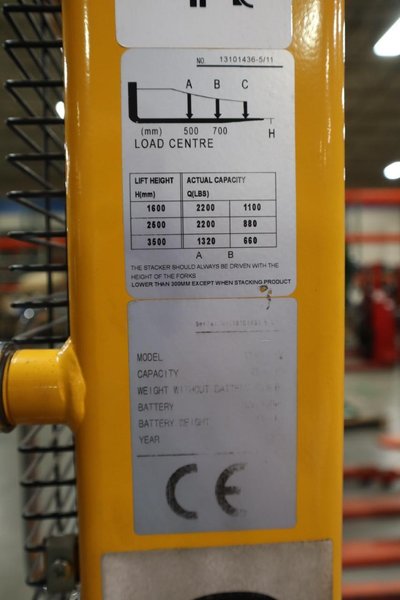 Uline H-2651 Electric Straddle Stacker Lift, 2,200# Cap, 63&quot; Max Height, 50&quot; Between Outriggers, 12 Volt Battery with Charger, 42&quot; Forks- Auction Item