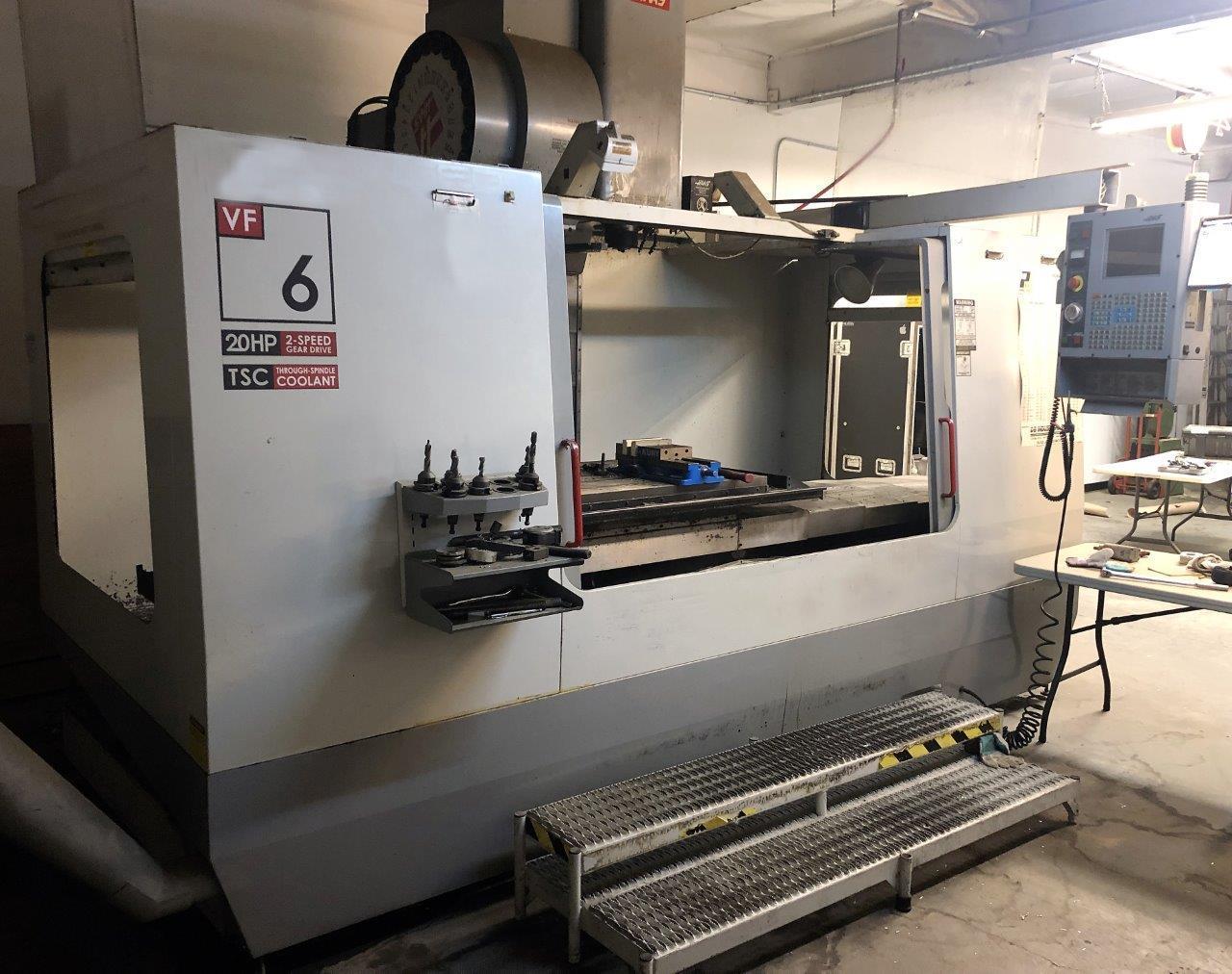 Haas VF-6B/40 VMC 2002 With: Brushless Servo, 7.5K RPM 2-Speed Gearbox Spindle, Extended Memory, Through Spindle Coolant, Programmable Coolant, Rigid Tap, and Chip Conveyor.