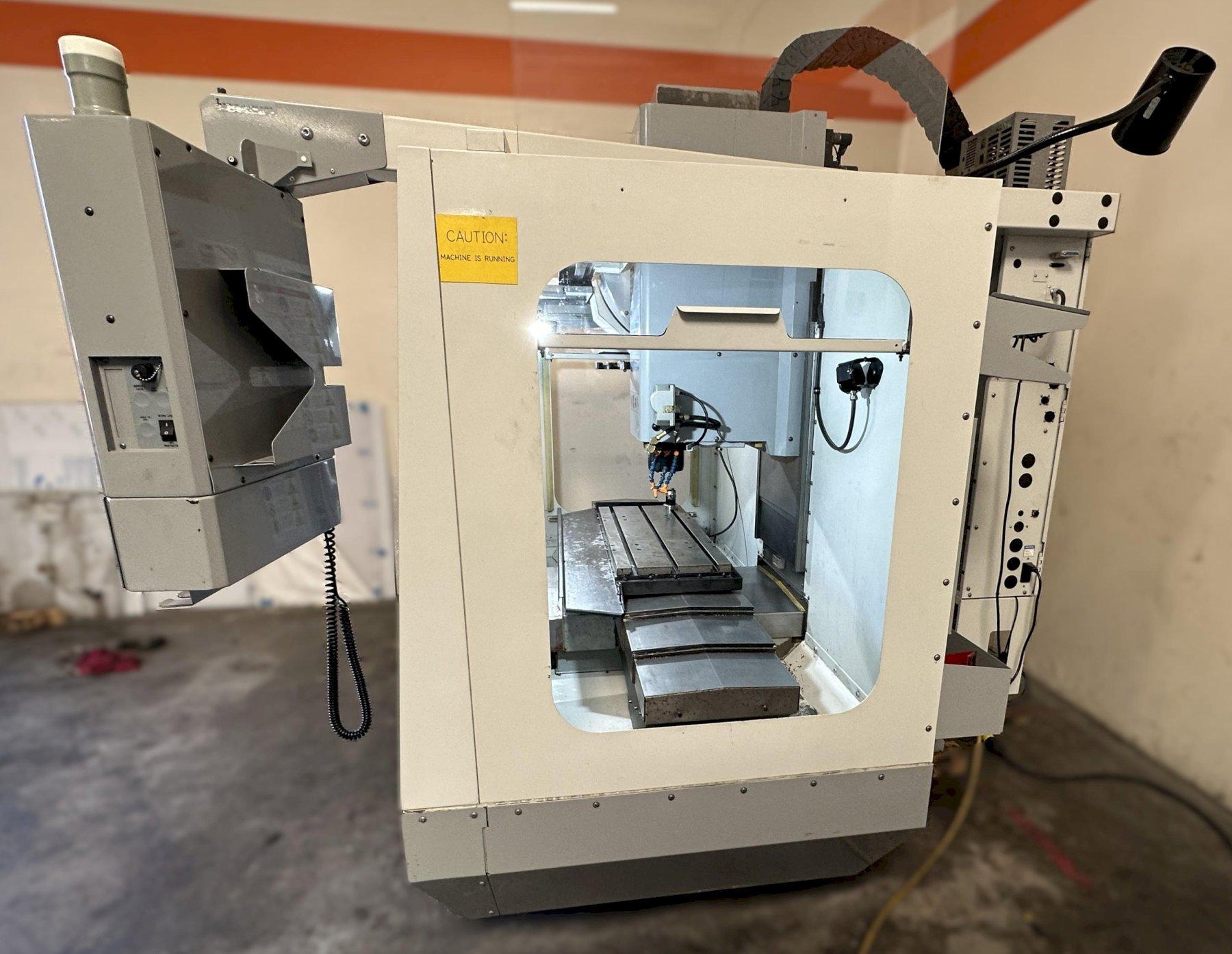 Haas VF-2D Vertical Machining Center 2007 With Rigid Tap, Remote Hand Jog, P-Cool, 4th Axis & 5th Axis Drives, 10,000 RPM Spindle, Chip Auger
