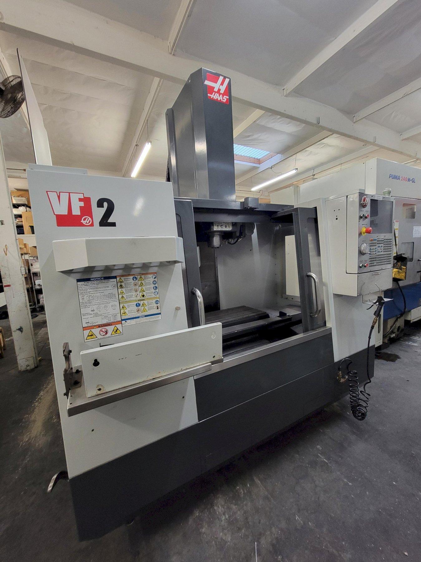 Haas VF-2 VMC equipped with Chip Auger, Rigid Tapping Programmable Coolant 2-Speed Gear Box