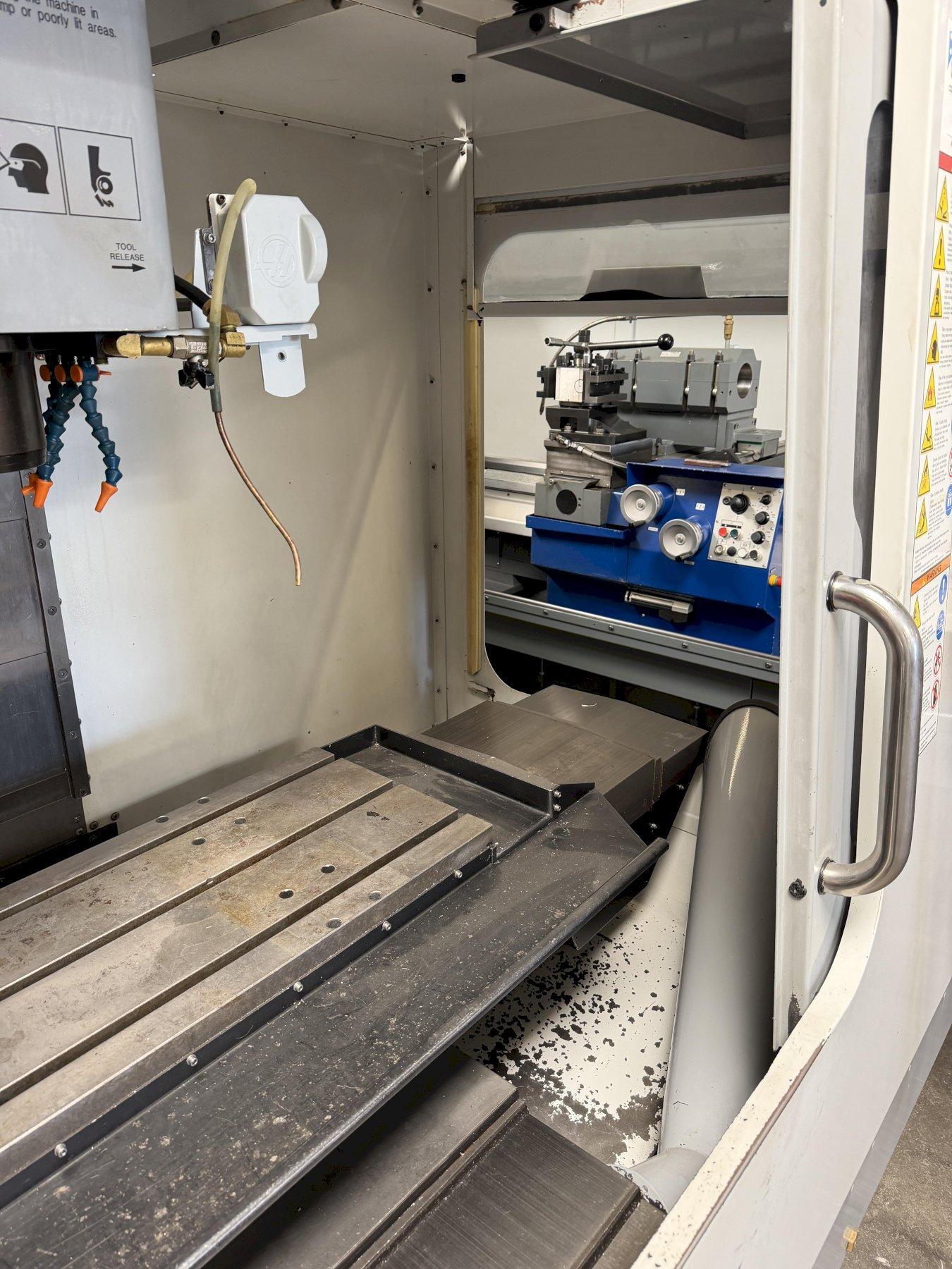 Haas VF-2B Vertical Machining Center 2007 With 2 Speed Gear Box, Rigid Tap, Remote Hand Jog, P-Cool, Hil, 4th Axis Ready, 10,000 RPM Spindle, Chip Auger