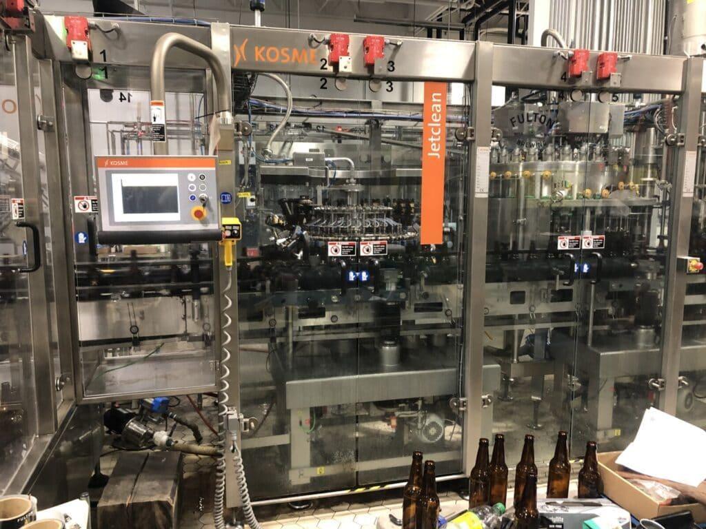 Krones Kosme 150 BPM Complete Bottling Line, 2014 – 28-Valve Filler, 7-Head Capper, Labeler, Depalletizer & Case Packer