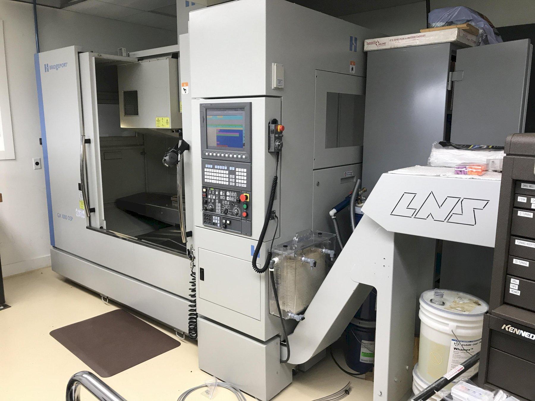 Hardinge Bridgeport GX1000 OSP Vertical Machining Center 2012 equipped with OSP-P300M-R,  Lift Up Chip Conveyor, CTS, Side Mounted Tool Changer, Coolant Tank.  LESS THAN 130 CUTTING HOURS !!