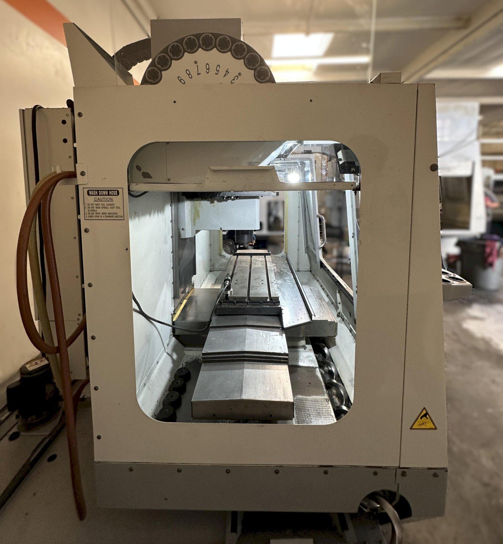 Haas VF-2D Vertical Machining Center 2007 With Rigid Tap, Remote Hand Jog, P-Cool, 4th Axis & 5th Axis Drives, 10,000 RPM Spindle, Chip Auger