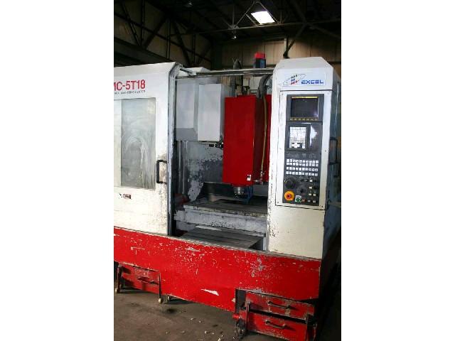 EXCEL PMC-5T18,  Fanuc 21M CNC Control With Monitor. Handwheel Jog. Keyboard RS232 Port. 3.5" Floppy Drive. Rigid Tapping. 18-Position Automatic Tool Changer. Flood Coolant.