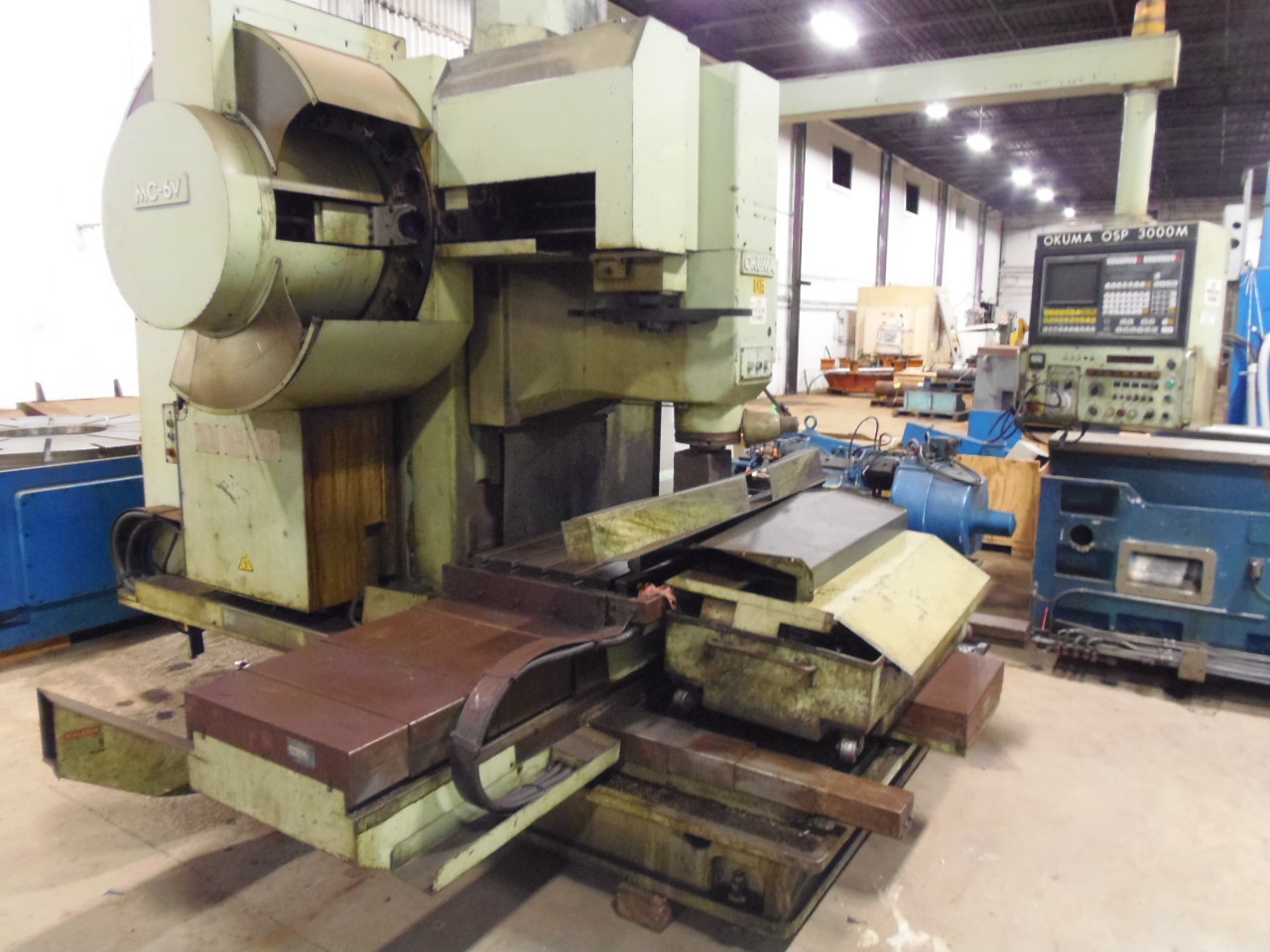 OKUMA MC-6V, 30" X 70" TABLE, 24 X 42 X 24 TRAVELS, 50 TAPER, 30 - 3600 RPM, OSP-3000 CONTROL WITH CRT, 20 ATC,