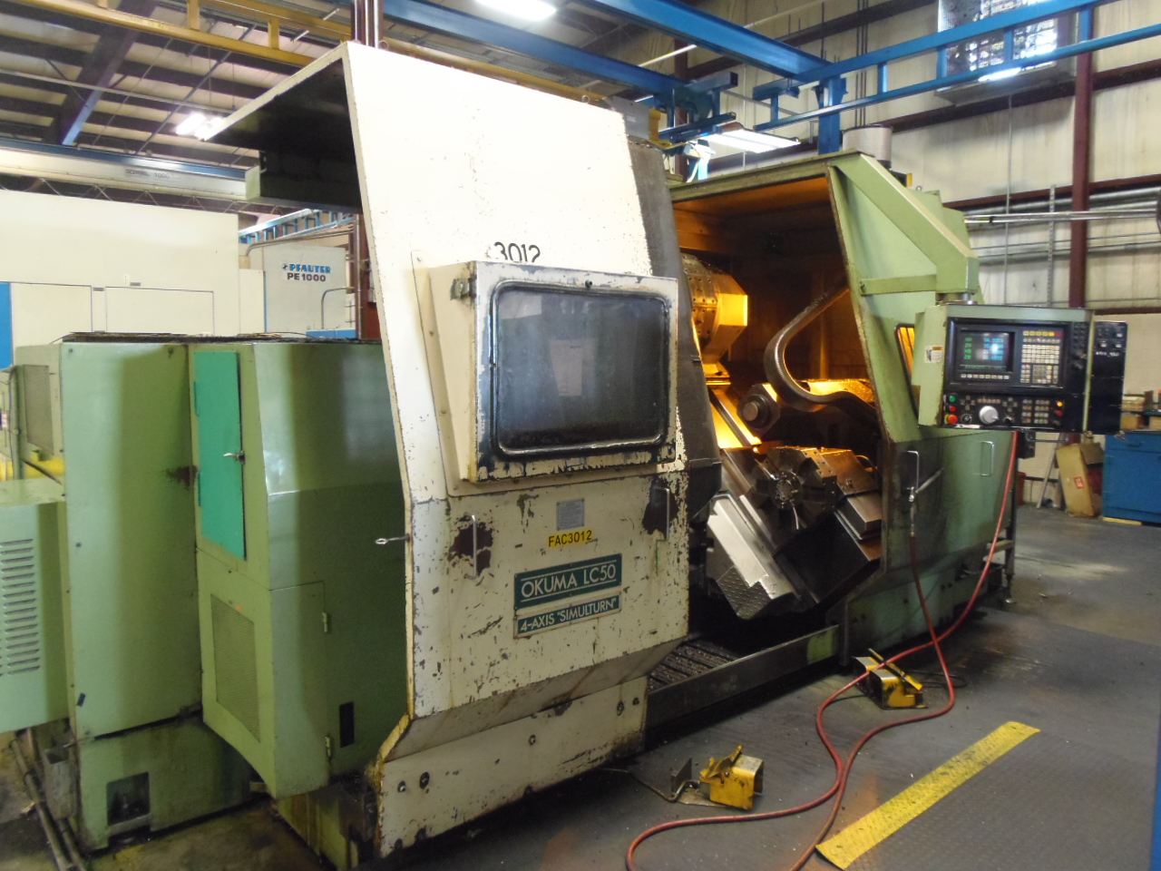 OKUMA LC-50-2S CNC LATHE, DUAL TURRET, 32" CHUCK, OSP5000L CONTROL, 75 HP, 49" CTRS, 6.9" BORE, 1989